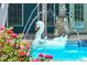 Swimming pool featuring water fountain and swan float, set amongst colorful flowers and greenery at 65 Maude White Rd, Kingston, GA 30145