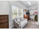 Bright walk-in closet has window, seating, carpet and custom shelving for ample storage at 65 Maude White Rd, Kingston, GA 30145