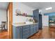 Stylish wet bar featuring modern countertops, sleek cabinetry, and wood look flooring at 65 Maude White Rd, Kingston, GA 30145