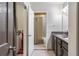 Hallway view of bathroom with double vanity, washer and dryer, and shower with tile surround at 1150 Collier Nw Rd # K18, Atlanta, GA 30318