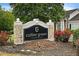 Community sign for Collier Green Condominiums, surrounded by mature trees and landscaping at 1150 Collier Nw Rd # K18, Atlanta, GA 30318