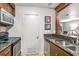 Modern kitchen with granite countertops, stainless steel appliances, and wood trim at 1150 Collier Nw Rd # K18, Atlanta, GA 30318