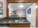 Open kitchen pass-through, granite countertops, and view into spacious living area at 1150 Collier Nw Rd # K18, Atlanta, GA 30318