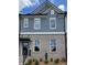 Charming townhome with brick and gray shingle exterior and well-maintained landscaping at 1262 Ainsworth Aly # 48, Sugar Hill, GA 30518