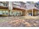 View of a backyard featuring brick patios, elevated decks, and lawn at 2919 Camplay Dr, Suwanee, GA 30024