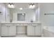 Spacious bathroom featuring a double vanity, a large mirror, and stylish fixtures at 2919 Camplay Dr, Suwanee, GA 30024