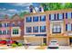 Charming brick townhome with a two-car garage and well-maintained landscaping and blue shutters at 2919 Camplay Dr, Suwanee, GA 30024