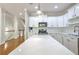 Modern kitchen with white cabinets, stainless steel appliances, quartz countertops, and island at 2919 Camplay Dr, Suwanee, GA 30024