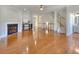 Spacious living room with gleaming hardwood floors, a fireplace, and access to staircase at 2919 Camplay Dr, Suwanee, GA 30024