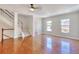 Bright living room featuring hardwood floors, white walls, and staircase access at 2919 Camplay Dr, Suwanee, GA 30024