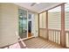 View from screen porch into kitchen with stainless fridge and sliding door to deck at 2919 Camplay Dr, Suwanee, GA 30024