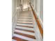 Elegant staircase featuring wooden treads and risers, contrasted by white trim and wooden handrail at 2919 Camplay Dr, Suwanee, GA 30024