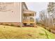 Side view of the covered back porch and sloping backyard with new sod at 3390 Hillshire Dr, Cumming, GA 30028
