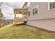 Side view of the covered back porch and sloping backyard with new sod at 3390 Hillshire Dr, Cumming, GA 30028