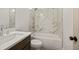 Bathroom showcasing a marble-tiled shower, white vanity, and chrome fixtures at 3390 Hillshire Dr, Cumming, GA 30028