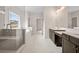 Bathroom featuring a tiled shower, soaking tub, double sink vanity, and abundant natural light at 3390 Hillshire Dr, Cumming, GA 30028