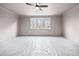 Unfurnished bedroom with large window and ceiling fan at 3390 Hillshire Dr, Cumming, GA 30028