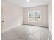 A bedroom with a window provides ample natural light and a view of the outdoors at 3390 Hillshire Dr, Cumming, GA 30028