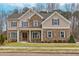 Charming two-story home featuring a blend of brick and siding, well-manicured lawn, and inviting front entrance at 3390 Hillshire Dr, Cumming, GA 30028