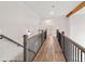 Hallway featuring wood floors, railing, and an open view to another room at 3390 Hillshire Dr, Cumming, GA 30028