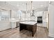 Well-lit kitchen showcasing a large center island and modern fixtures at 3390 Hillshire Dr, Cumming, GA 30028