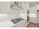 Close-up of the cooktop, showing stainless steel vent hood and white backsplash at 3390 Hillshire Dr, Cumming, GA 30028