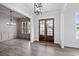 Open-concept living area with hardwood floors, elegant lighting fixtures, access to dining room and a view of the front entrance at 3390 Hillshire Dr, Cumming, GA 30028