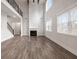 Bright living room featuring high ceilings, a fireplace, and large windows at 3390 Hillshire Dr, Cumming, GA 30028