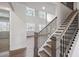 Bright and airy living room with hardwood floors, a modern staircase, and large windows offering views of the outdoors at 3390 Hillshire Dr, Cumming, GA 30028