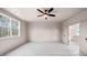 Main bedroom with a ceiling fan, an adjacent bathroom with tub and shower at 3390 Hillshire Dr, Cumming, GA 30028