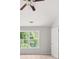 Bright bedroom featuring a ceiling fan and a large window providing ample natural light at 145 Redsage Rdg, Atlanta, GA 30349