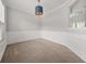 Formal dining room with neutral carpet, crown molding and a stylish light fixture at 145 Redsage Rdg, Atlanta, GA 30349