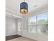 Bright dining area featuring a modern pendant light, wainscoting, and a view to front yard at 145 Redsage Rdg, Atlanta, GA 30349