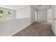 Hallway featuring neutral carpet and natural light from the nearby window at 145 Redsage Rdg, Atlanta, GA 30349