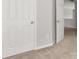 Hallway featuring neutral carpet, white trim, and white door at 145 Redsage Rdg, Atlanta, GA 30349