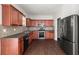 Well-equipped kitchen featuring stainless steel appliances, dark cabinets, and granite countertops at 145 Redsage Rdg, Atlanta, GA 30349
