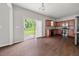 Open kitchen featuring stainless steel appliances, dark hardwood floors, and a sliding glass door at 145 Redsage Rdg, Atlanta, GA 30349