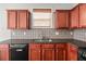 Kitchen featuring dark cabinetry, stainless steel appliances and complimentary tile backsplash at 145 Redsage Rdg, Atlanta, GA 30349