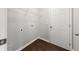 Clean laundry room featuring hardwood floors and a wire rack at 145 Redsage Rdg, Atlanta, GA 30349