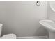 Bright powder room with modern pedestal sink and decor at 145 Redsage Rdg, Atlanta, GA 30349