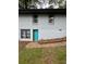 Exterior view of a grey painted brick house with a turquoise door and brick pathway at 2874 Cloverleaf Se Dr, Atlanta, GA 30316