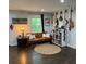 Cozy living room featuring a brown leather sofa, area rug and guitar collection at 2874 Cloverleaf Se Dr, Atlanta, GA 30316