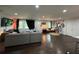 Open concept living room with dark hardwood floors and a large grey sectional sofa at 2874 Cloverleaf Se Dr, Atlanta, GA 30316