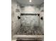 Contemporary shower with mosaic tiled floor and white marble walls at 2874 Cloverleaf Se Dr, Atlanta, GA 30316