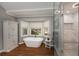Luxurious bathroom with a standalone tub, walk-in shower, and stylish wood look floors at 4540 Saddle Se Ct, Smyrna, GA 30082