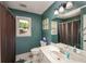 Stylish bathroom with a window, shower, and vanity with sink at 4540 Saddle Se Ct, Smyrna, GA 30082