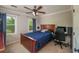 Comfortable bedroom with a wood bed, two windows, and a ceiling fan at 4540 Saddle Se Ct, Smyrna, GA 30082