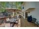 The outdoor deck with umbrella-covered table, hot tub, and views of the backyard at 4540 Saddle Se Ct, Smyrna, GA 30082