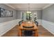 Traditional dining room with wainscoting, a bay window, and a wooden dining table at 4540 Saddle Se Ct, Smyrna, GA 30082