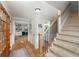Inviting entryway with a view of the home office, hardwood floors and carpeted stairs at 4540 Saddle Se Ct, Smyrna, GA 30082